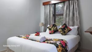 a bedroom with a bed with a window at NeemTree Villa- 5 Bedroom House On Its Own in Nadi