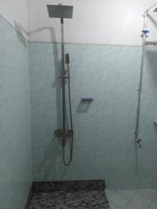 a shower in a bathroom with a glass wall at 4Seasons Holiday Home in Ratnapura