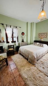 a bedroom with a large bed with a rug at Guesthouse Filokalia in Portaria