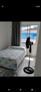 a bedroom with a bed and a view of the ocean at Cidades Portuguesas in Florianópolis