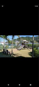 a park with a playground with a bench and a swing at Cidades Portuguesas in Florianópolis