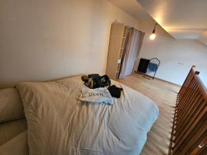 a bag sitting on a bed in a room at La petite maison in Schiltigheim