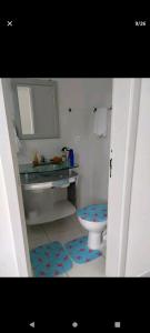 a bathroom with a sink and a toilet and a mirror at Cidades Portuguesas in Florianópolis
