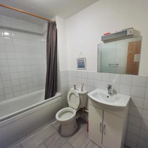 a bathroom with a toilet and a sink at All saints Rooms in London +87 photos