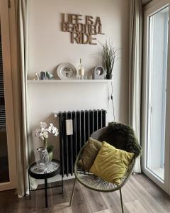 een woonkamer met een stoel en een radiator bij Cascina GianTino G A Y - ONLY suite Cantina in Montegrosso dʼAsti