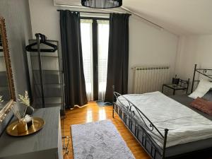 a bedroom with a bed and a large window at Ferienhaus Marija mit Pool in Vilanija