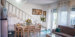 a dining room with a table and chairs at Villa Viola - 350 mt from the beach - Outdoor Jacuzzi in Terracina