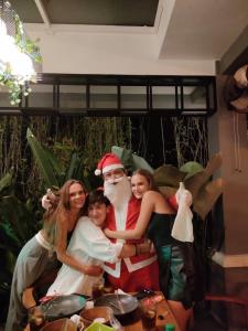 a group of people posing for a picture with santa claus at The Jiwana Bali Resort in Ungasan