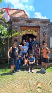 a group of people posing for a picture in front of a building at The Jiwana Bali Resort in Ungasan