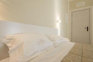 Postel nebo postele na pokoji v ubytování B&B Torre dei Monaci