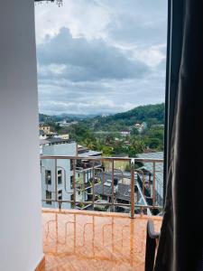 a view of a city from a balcony at Sakura hotel and restaurant in Kandy
