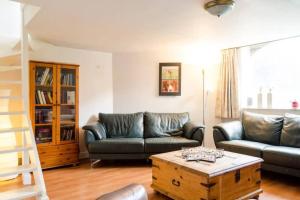 a living room with two couches and a coffee table at Historical house on river Vecht in Maarssen