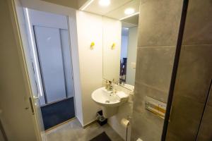 a bathroom with a sink and a mirror at Uptown Elegant Apartment in Voluntari +22 photos