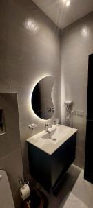 a bathroom with a sink and a mirror at palm shadow resort in Tunis
