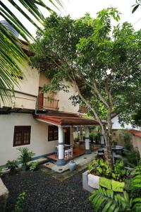 a house with a tree in front of it at Serene villa in Galle