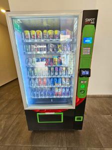a vending machine with drinks and drinks in it at Quartz Paragon Suites By GGM in Melaka