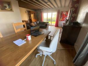 a living room with a desk with a laptop and a chair at Wellbet Farm in Lincoln