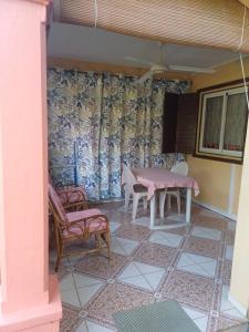 a dining room with a table and two chairs at Fleurvilla in Pereybere