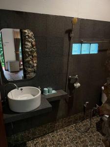 a bathroom with a sink and a mirror at Seafront Jungle Bungalow in Koh Phangan