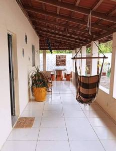 a living room with a porch with a hammock at Rochedo Casa de Praia in Nova Viçosa