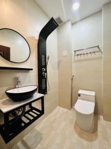 a bathroom with a sink and a toilet and a mirror at DREAM HOUSE in Ho Chi Minh City