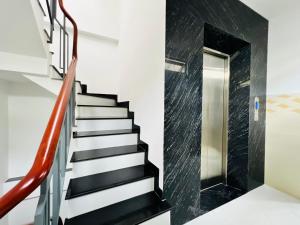 a staircase with black and white stairs and a glass door at DREAM HOUSE in Ho Chi Minh City