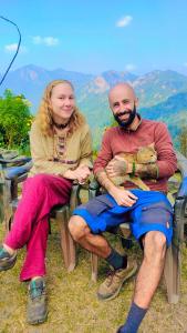 a man and a woman are sitting in chairs at TEC Resort and bar in Dharān Bāzār