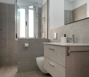 a bathroom with a toilet and a sink and a mirror at Casa Antonio - apartamento Luna in Playa de San Juan +27 photos
