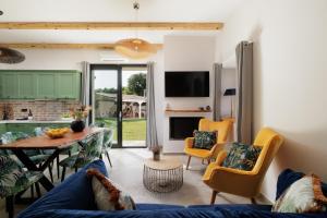 a living room with a blue couch and chairs at Villa n.RICCIO in Sokrakion