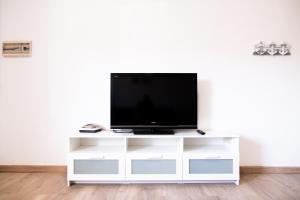 a flat screen tv on a white entertainment center at Casa Andrea Doria Arinaga B in Arinaga