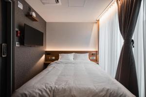 Postel nebo postele na pokoji v ubytování Pillowsopher Hongdae