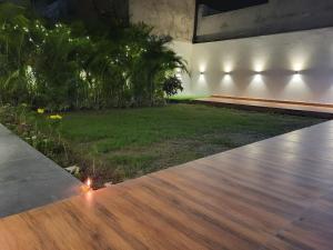 a patio with a wooden floor and a yard at Amritsar Homes - A perfect home away from home in Amritsar
