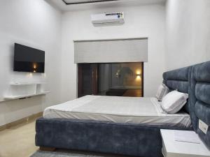 a bedroom with a bed and a couch at Amritsar Homes - A perfect home away from home in Amritsar