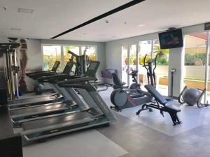 a gym with several treadmills and exercise bikes at Mercure São Paulo vila Olimpia premium in Sao Paulo