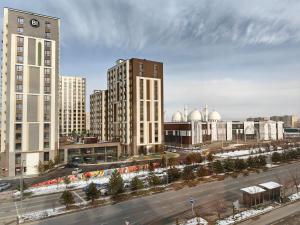 an aerial view of a city with tall buildings at Shymkent Park Hotel in Shymkent