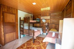 a room with two bunk beds and a door at Tío Felix Eco Lodge in Fortuna