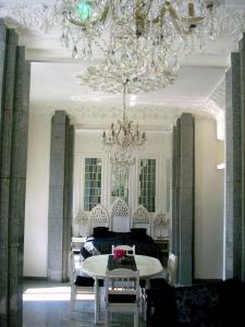 a living room with a bed and a chandelier at Fewo Meissen in Meißen