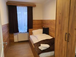 a small room with a bed and a window at VIENNA Premium Apartments - self check-in in Vienna