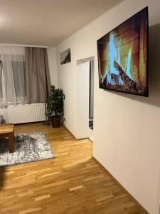 a living room with a television hanging on a wall at Wohnung in Hüttau in Sonnberg