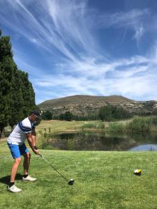 a man playing golf on a golf course at Swiss Chalet Clarens in Clarens