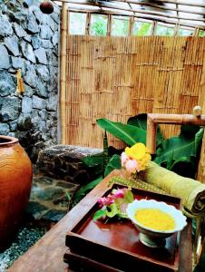 a table with a bowl of food on top of it at Banteay Srey Women's Only Traditional Spa and Homestay in Kampot
