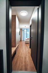 a hallway with a door open to a room with a bed at Jamy House in Habovka