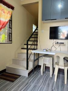 a dining room with a table and two chairs at The Quiet Villa in Tagaytay