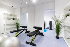 a gym with exercise bikes in a room with plants at Luxury sea view studio apartment in a skyscraper! in Tallinn