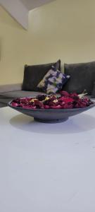 a plate of flowers on a table in front of a couch at ifrane house in Ifrane
