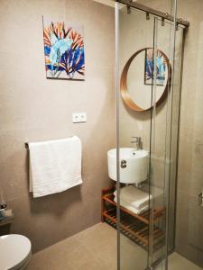 a bathroom with a sink and a mirror at AGAETE PARADISE in Puerto de las Nieves