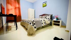 1 dormitorio con cama, mesa y piano en BAITH AL JANNAH LLC Vacation home Rentals, en Abu Dabi