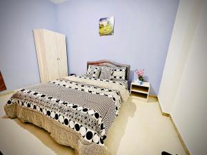 a bedroom with a large bed in a room at BAITH AL JANNAH LLC Vacation home Rentals in Abu Dhabi