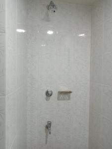 a shower stall in a bathroom with a shower at Hotel In Need - Near to the US and Canada Embassy in Dhaka in Dhaka