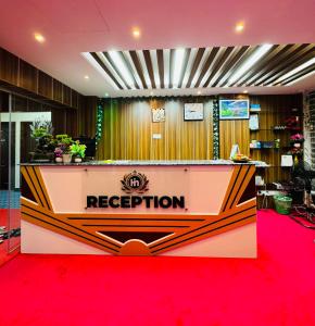 a reception desk in a room with a red carpet at Hotel In Need - Near to the US and Canada Embassy in Dhaka in Dhaka